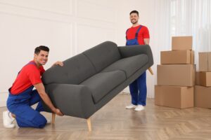 Professional movers carrying sofa in new house. Residential moving in Toronto year 2024